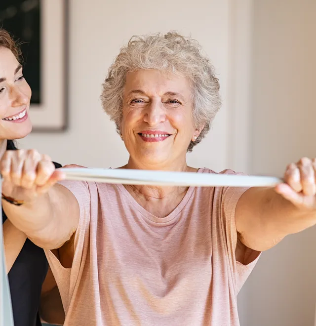 A nurse reviewing care notes with an older man at home