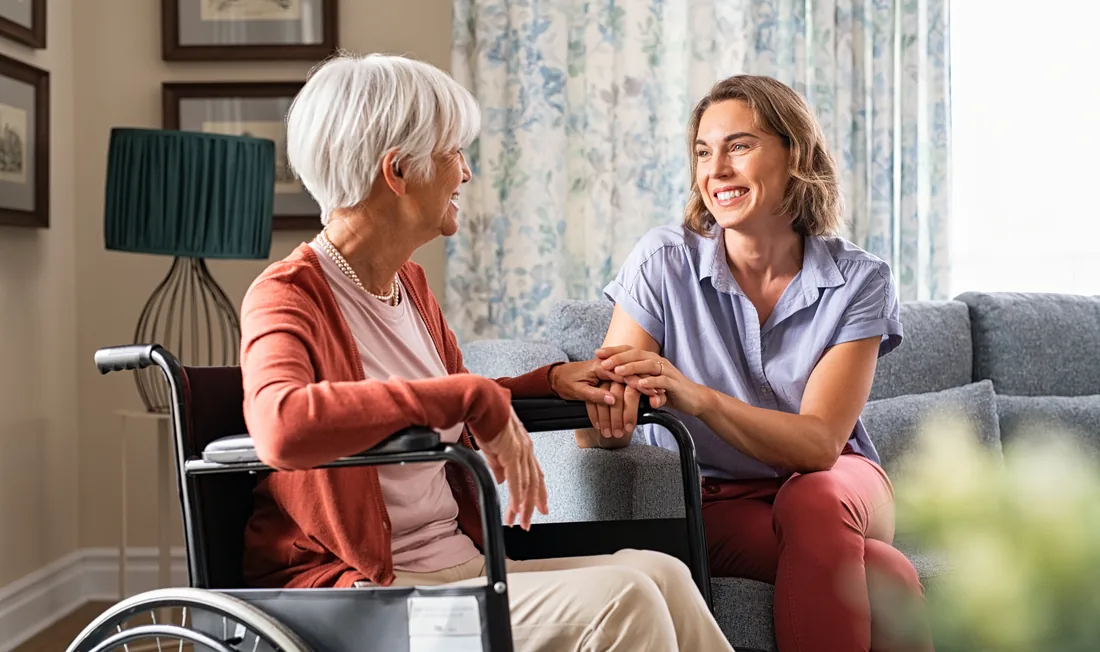 A People First Healthcare nurse and a family member talking with an older woman
